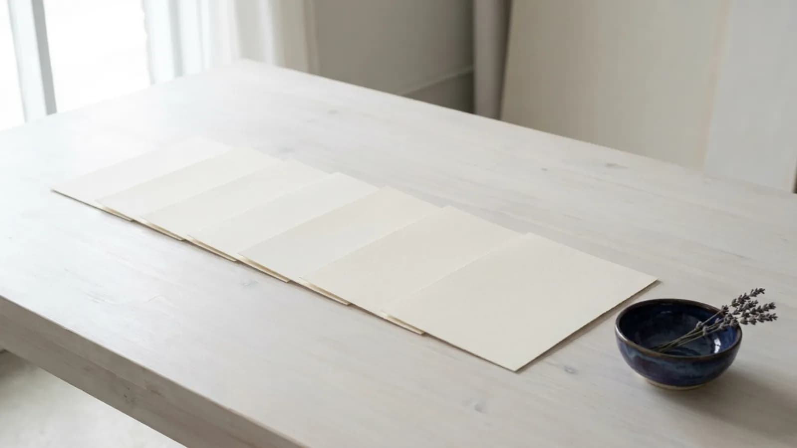Printed blank pages laid out in a row across a large table