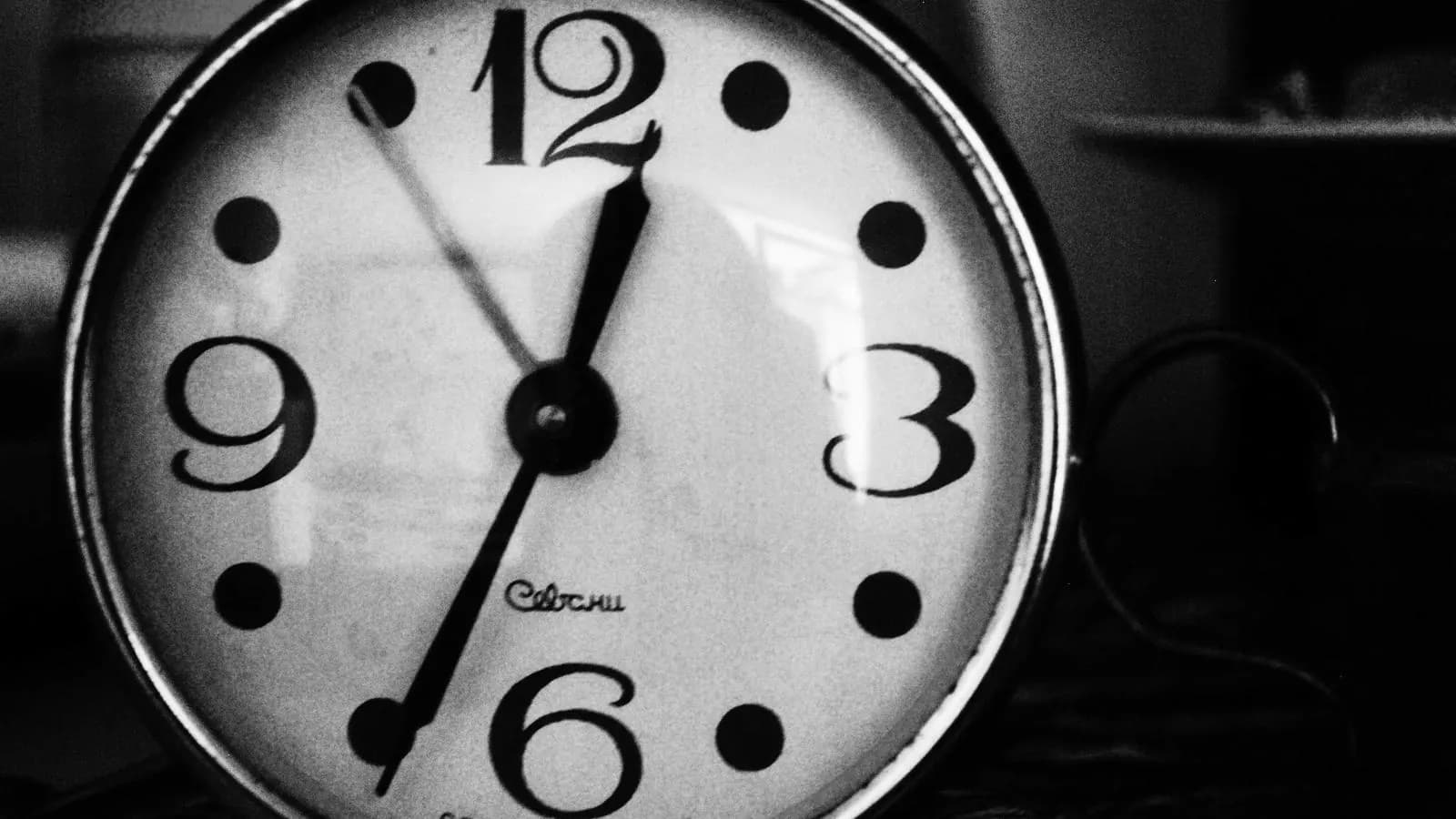 Black and white close-up of a round wall clock with bold numerals